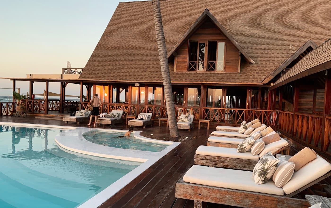 A hotel pool deck at the end of the day.