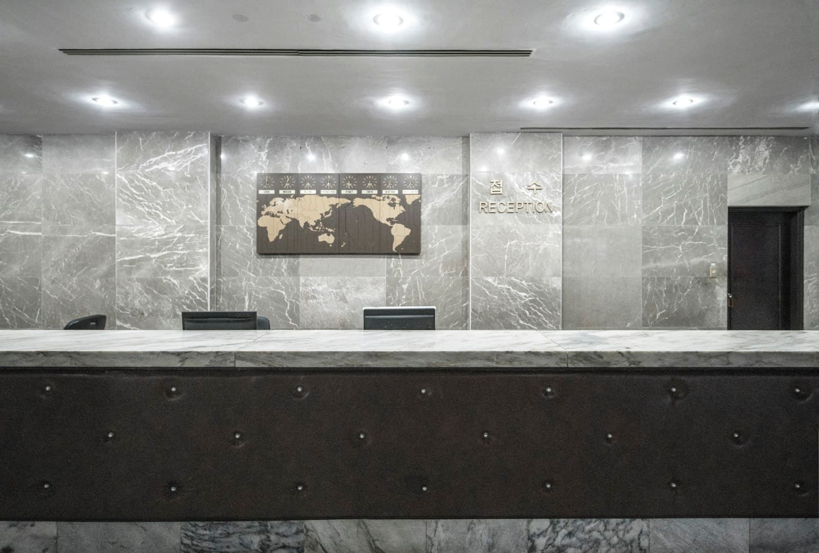 A hotel reception desk, empty and waiting.