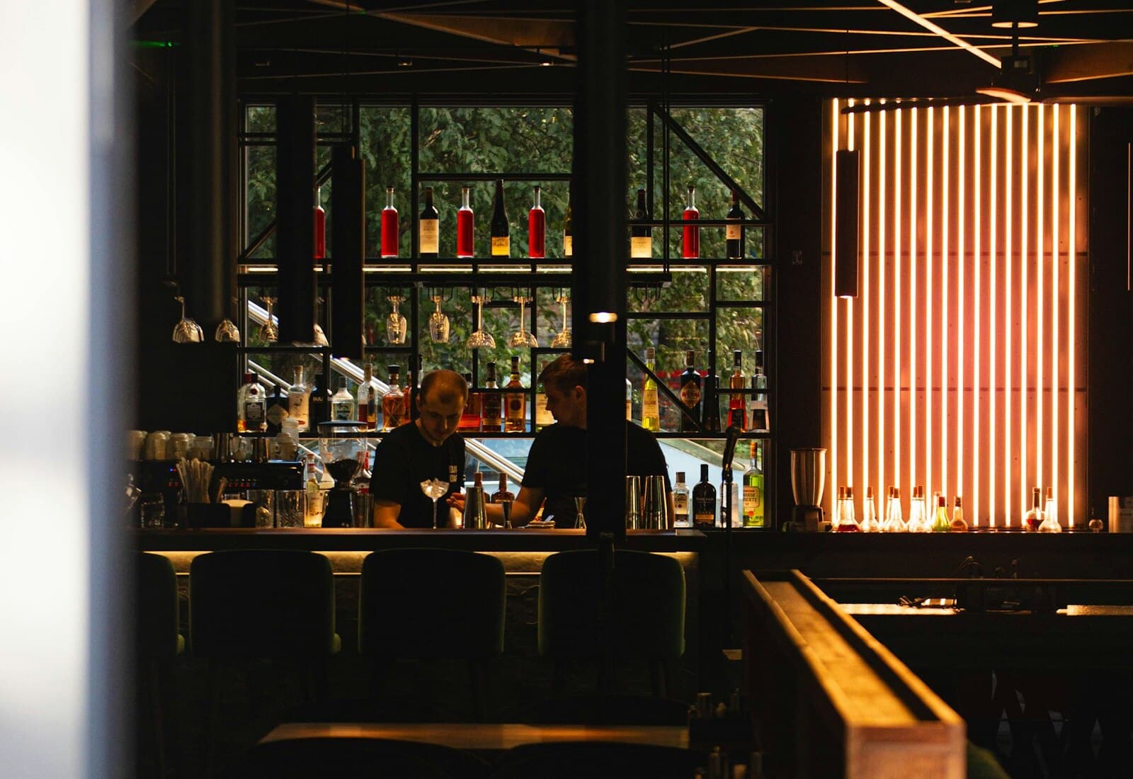 Two staff working the bar through service.