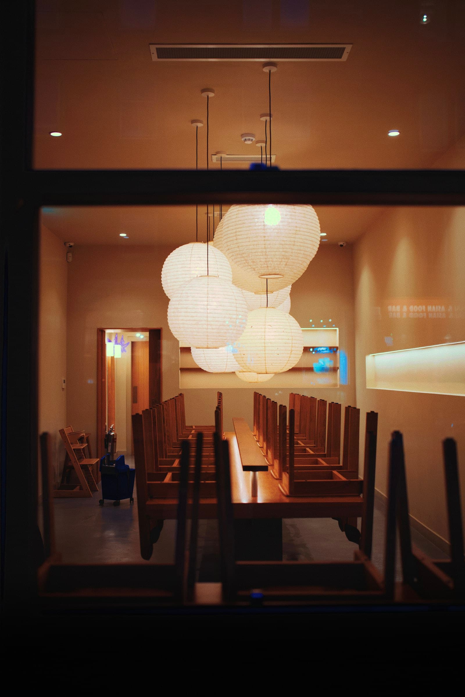 A closed room, lanterns still lit, nobody on the floor.