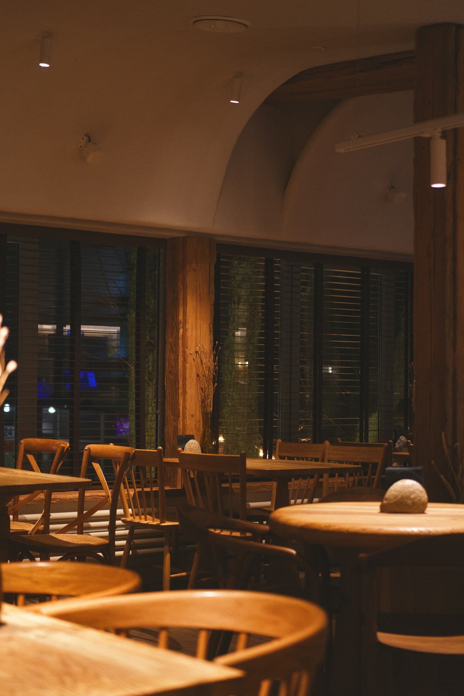A dining room lit and waiting on covers that have not come back.