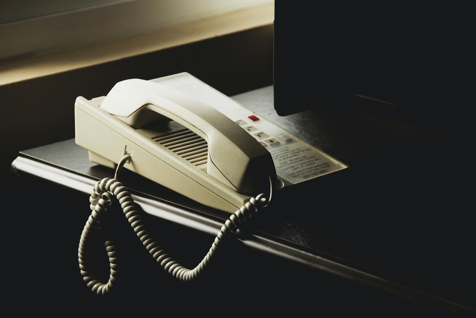 A desk phone on the counter, handset down.