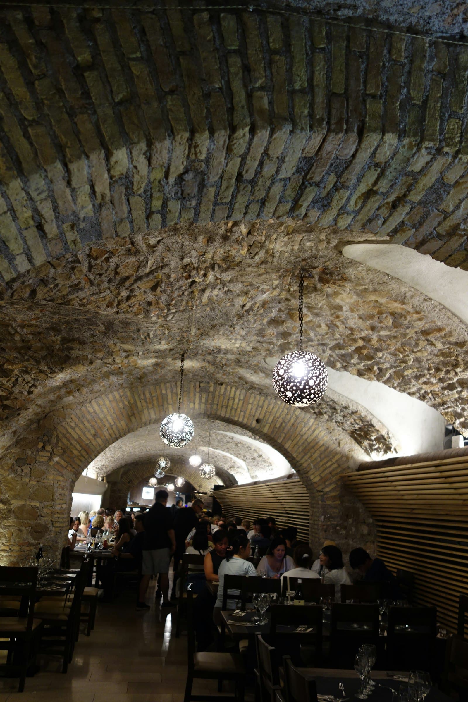 A function room under a vaulted ceiling, tables running the length of it.