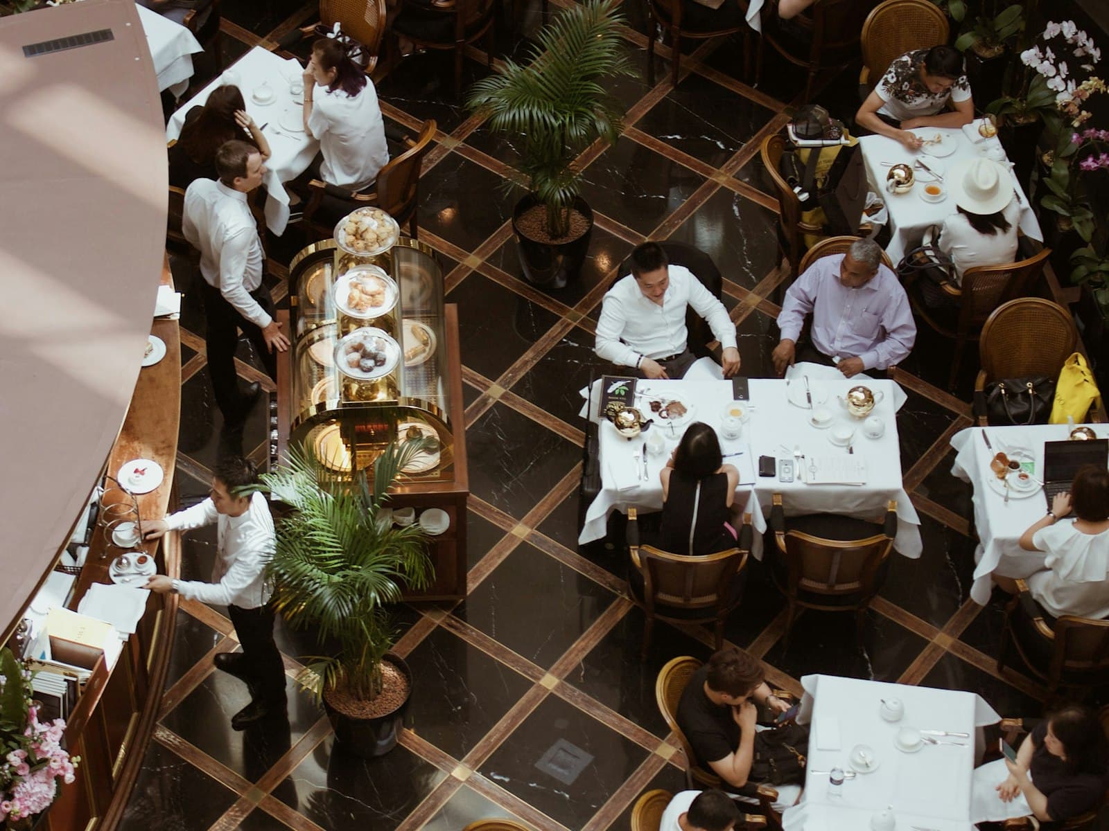 A dining room from above at service, every table being attended.