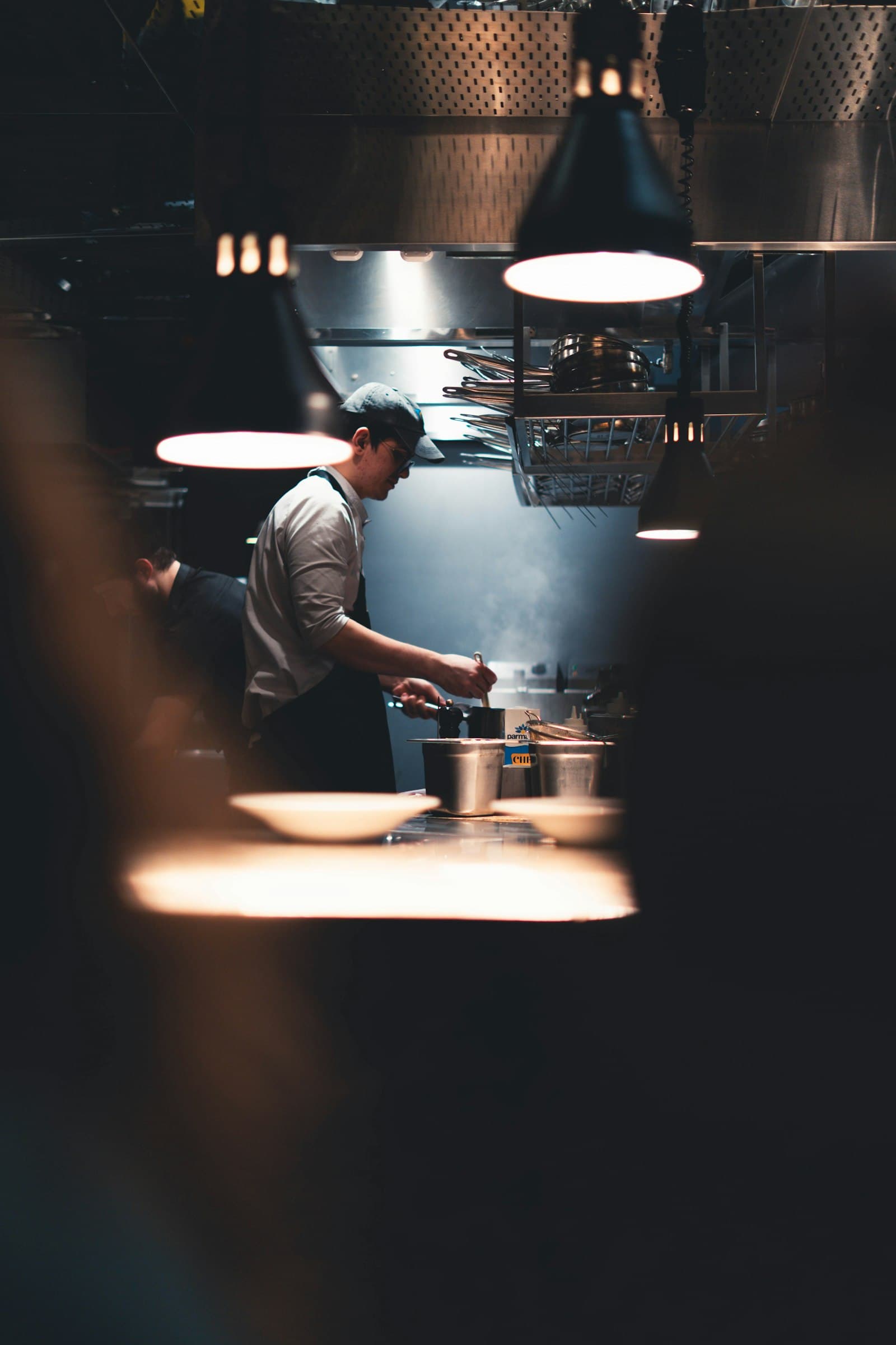 A cook plating under the pass light.
