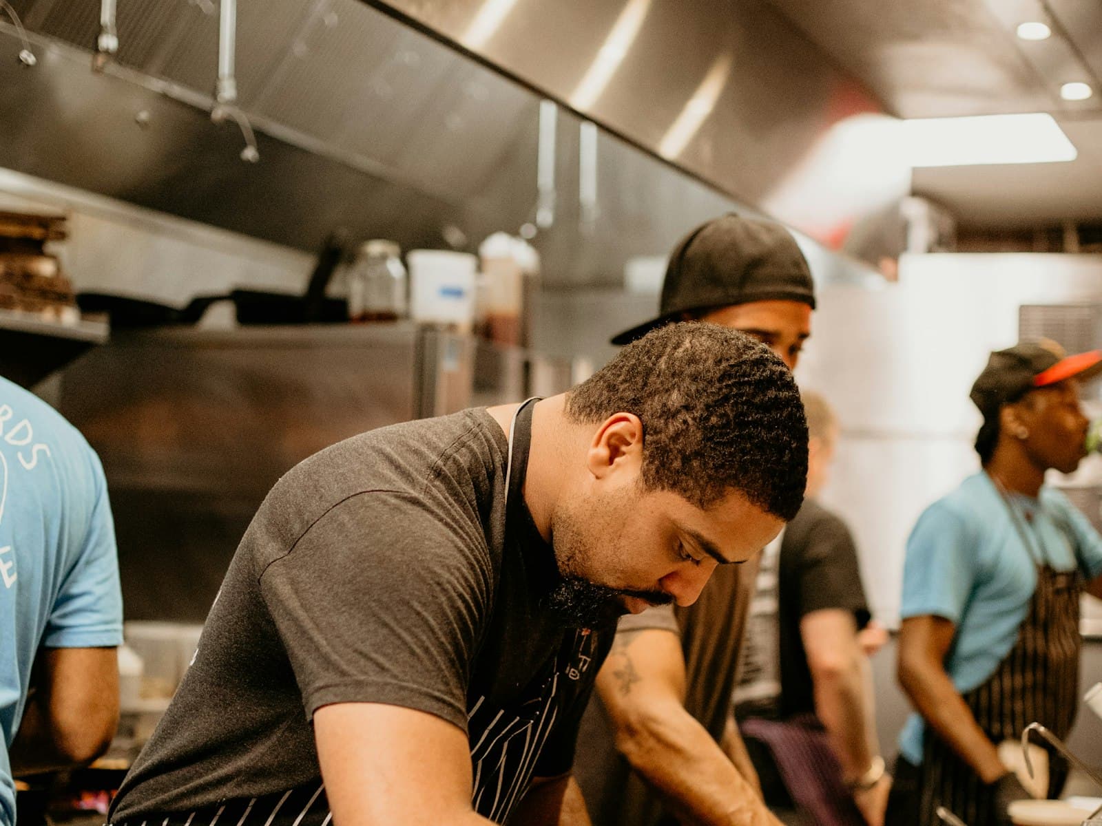 A cook working the board with the rest of the brigade behind him.