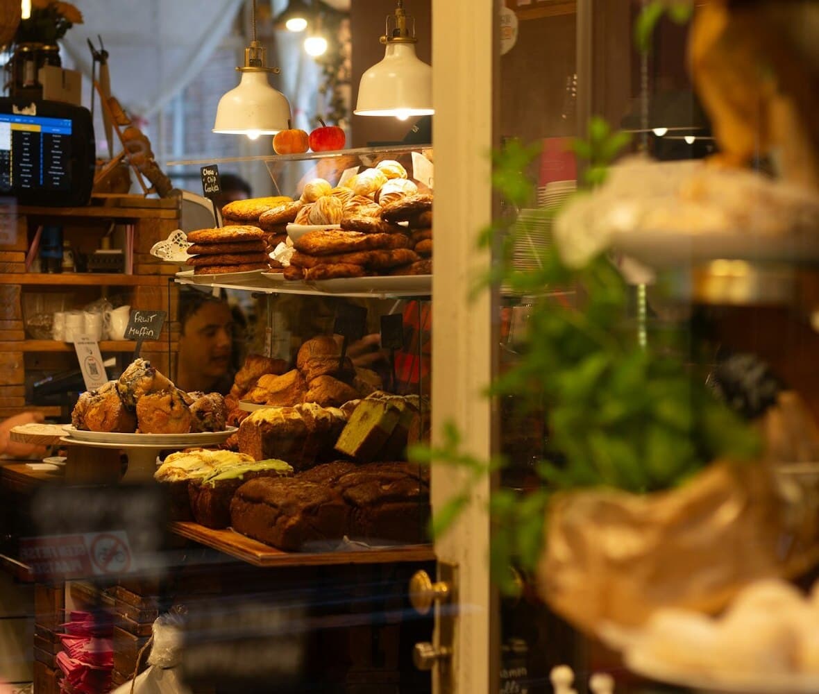 A counter mid-service, the cabinet full and someone waiting on it.